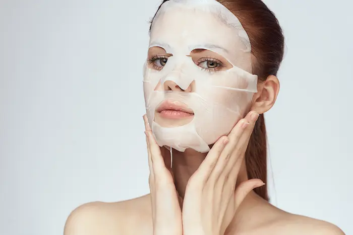 گذاشتن ماسک ورقه ای روی صورت زن 6767796